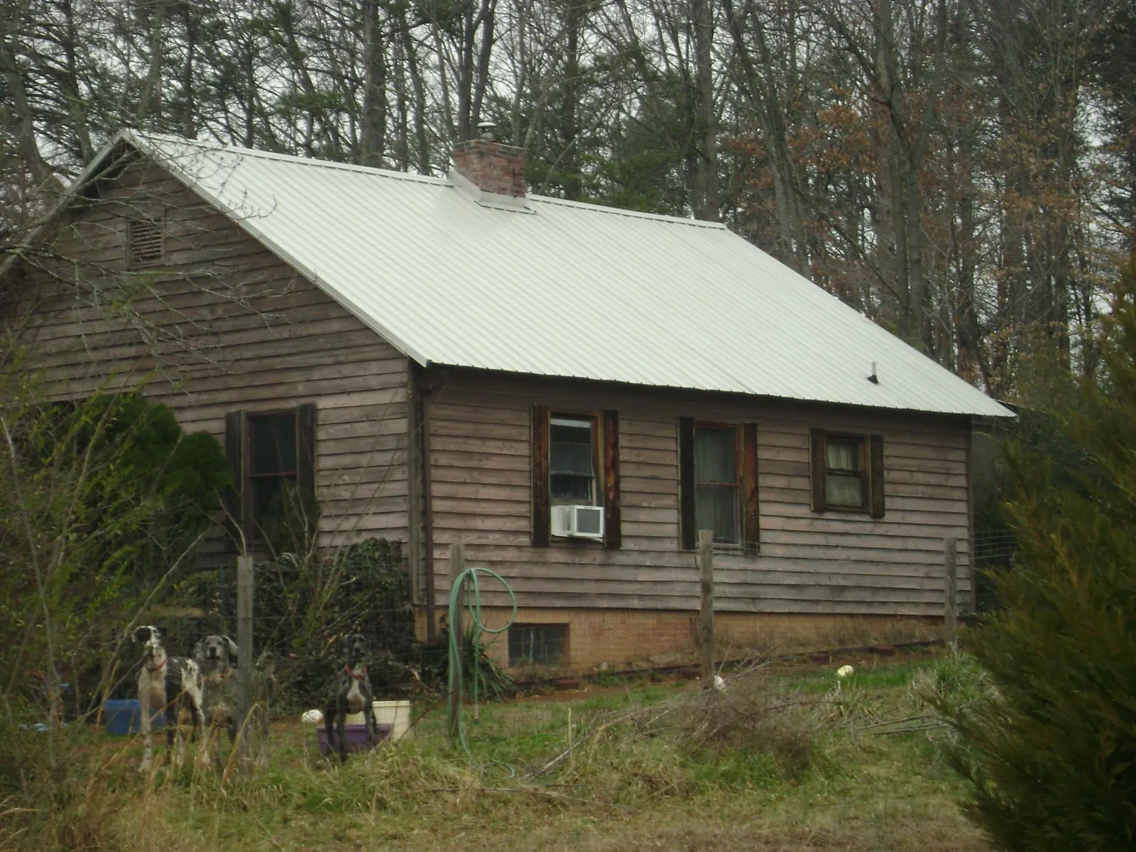 White metal roof on an old wood sided farmhouse, from a Metal Roof Installation job in Williamsport